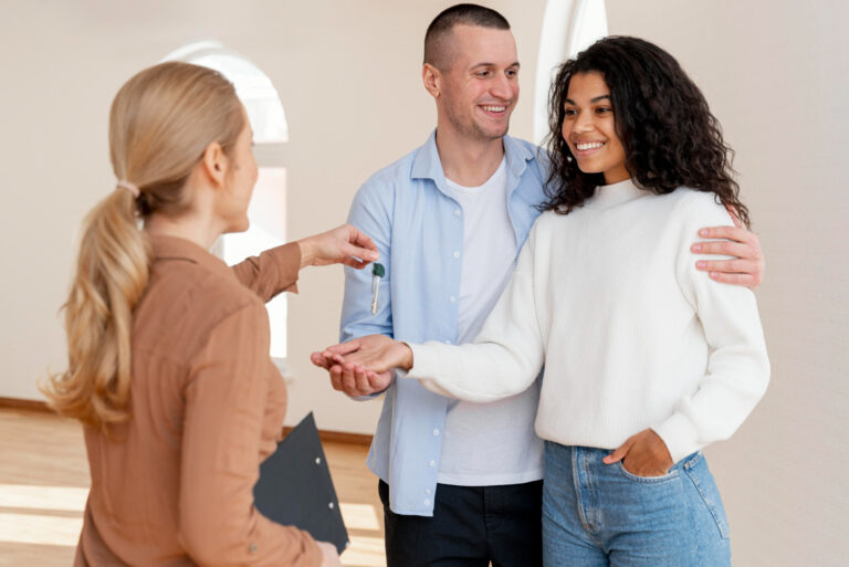 Realtor handling keys to home buyer's couple